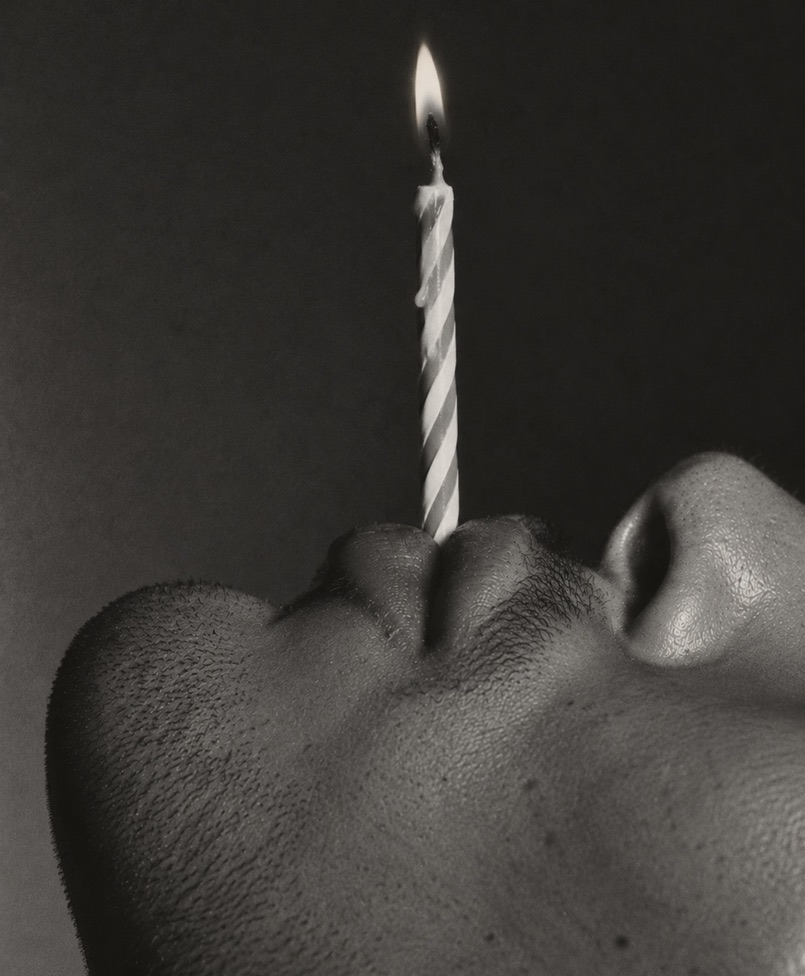 Profile portrait with a lit birthday candle